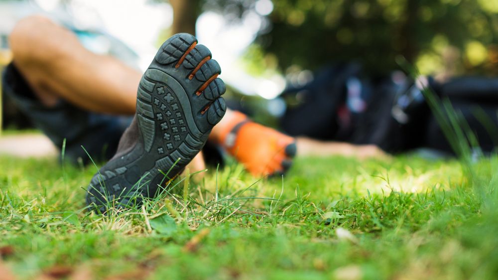 Man wearing barefoot sandals and sitting on the round