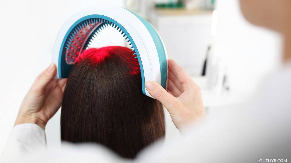 A woman doing a lowlevel laser therapy with the device getting placed on her head